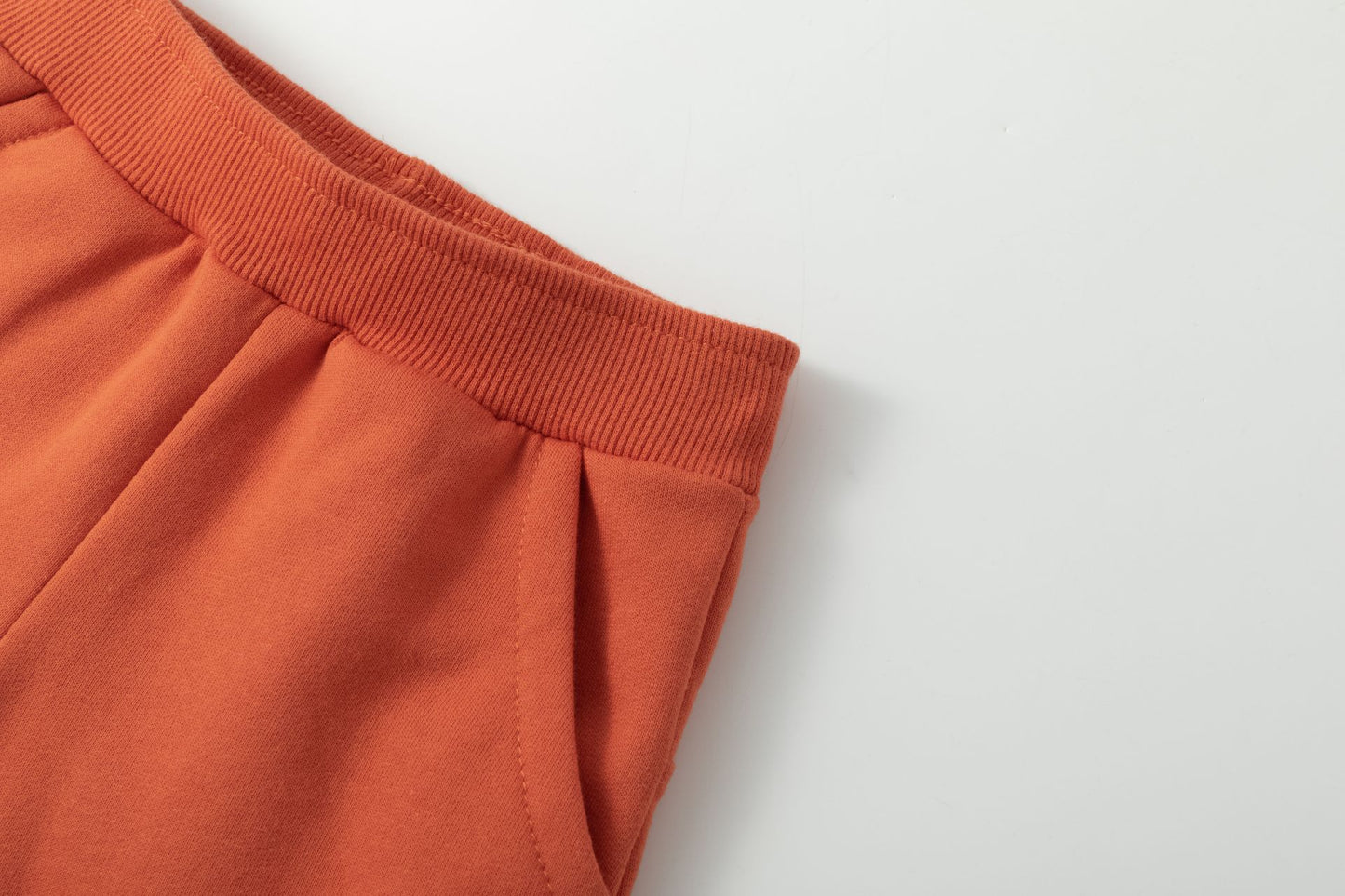 Pantalón deportivo bebe niño, de felpa perchada, con bolsillos laterales y canesú trasero. Gráfico de texto en el canesú estampado al agua y detalles en relieve. Gráfico de cara zorrito en la rodilla estampado al agua y detalles en relieve.