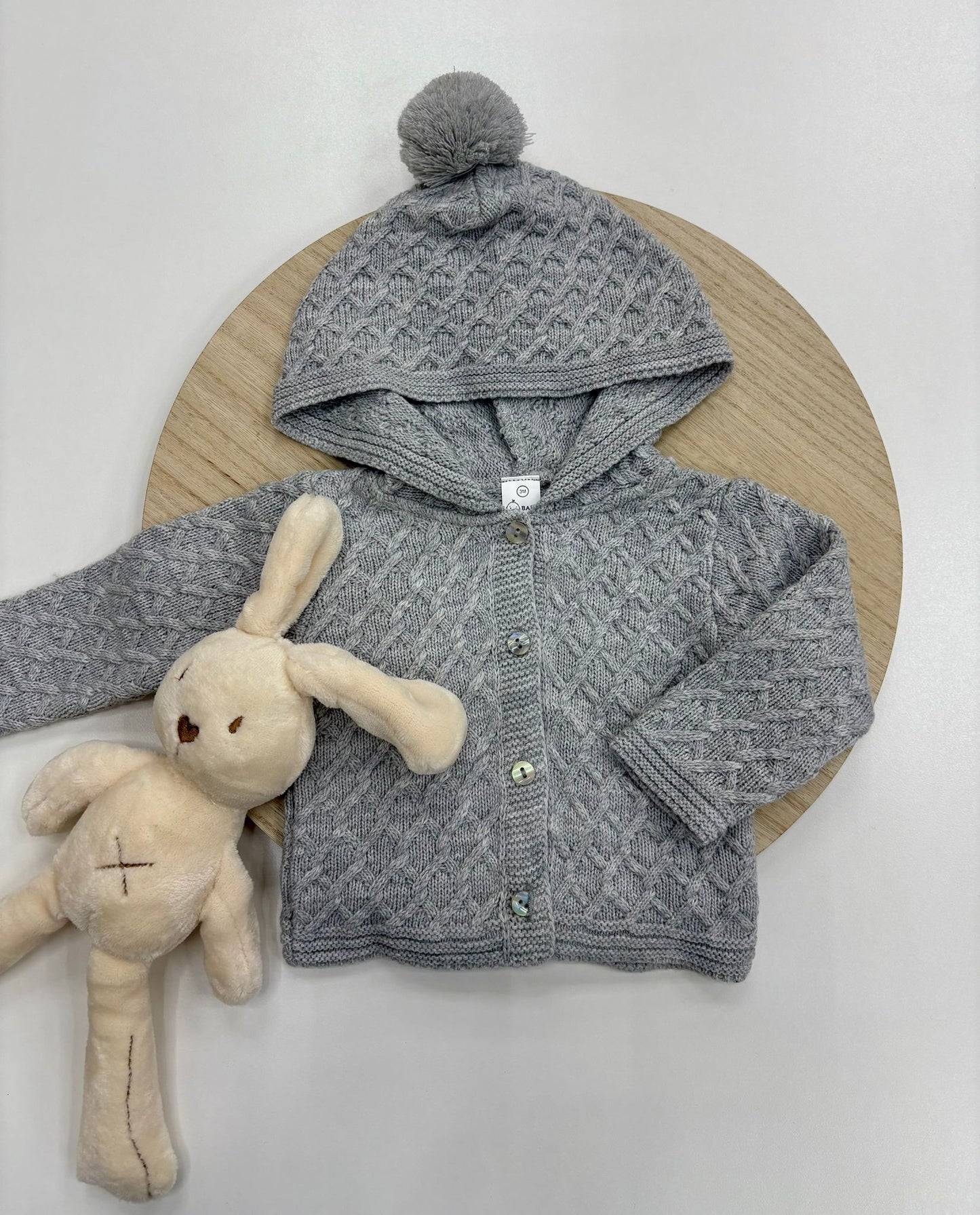 Chaqueta punto bebé con capucha y pompón color gris